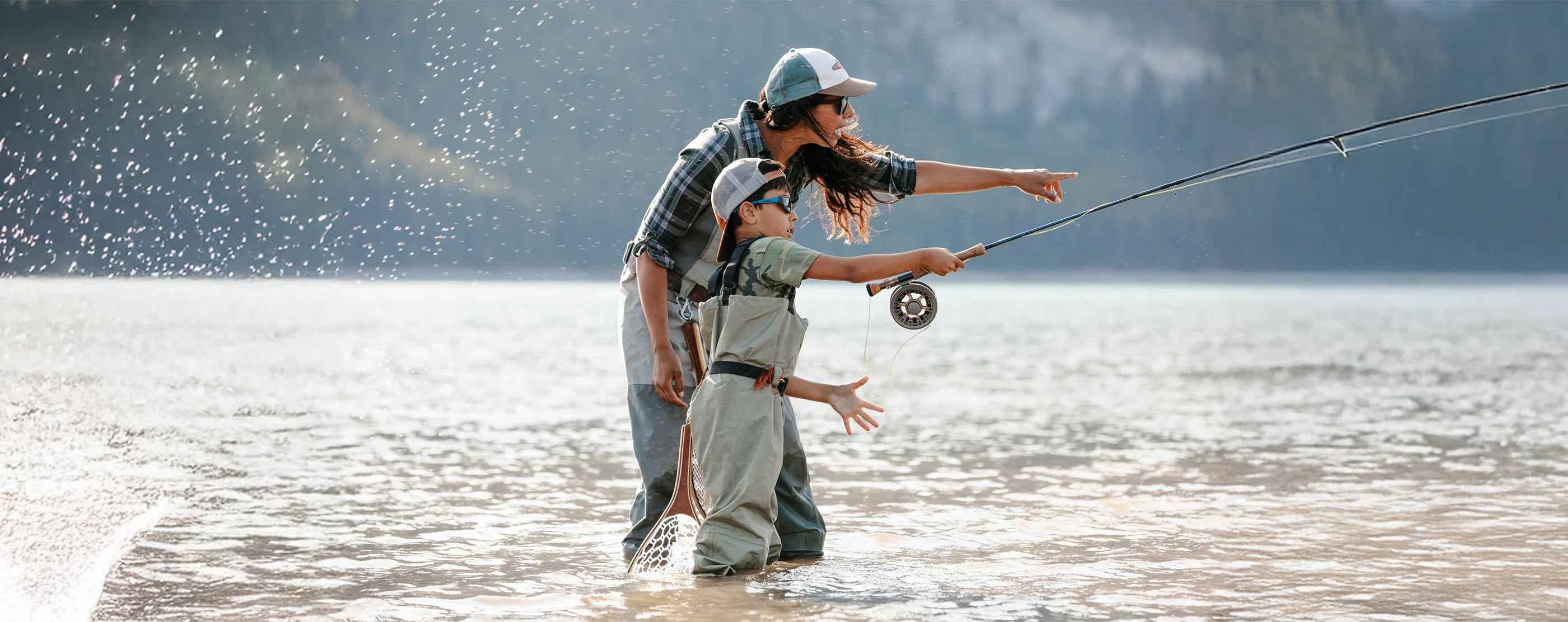 An adult and child fishing together